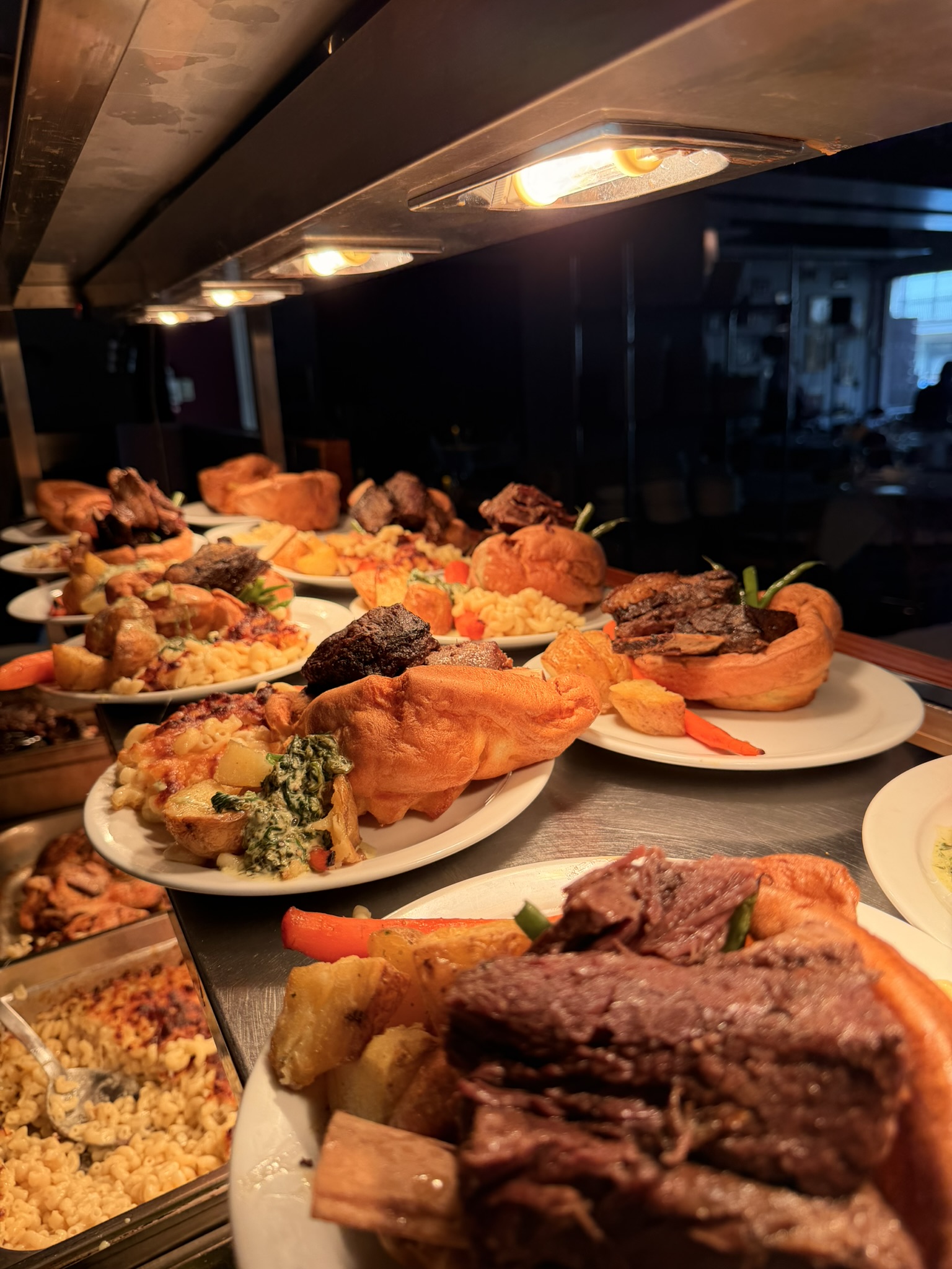 Sunday roast plates lined up at the pass